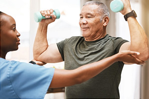 PACS-300x200-rehab2 A rehab therapist with a resident in the rehab gym
