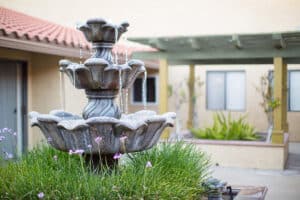 Water fountain and greenery in the Poway Healthcare courtyard