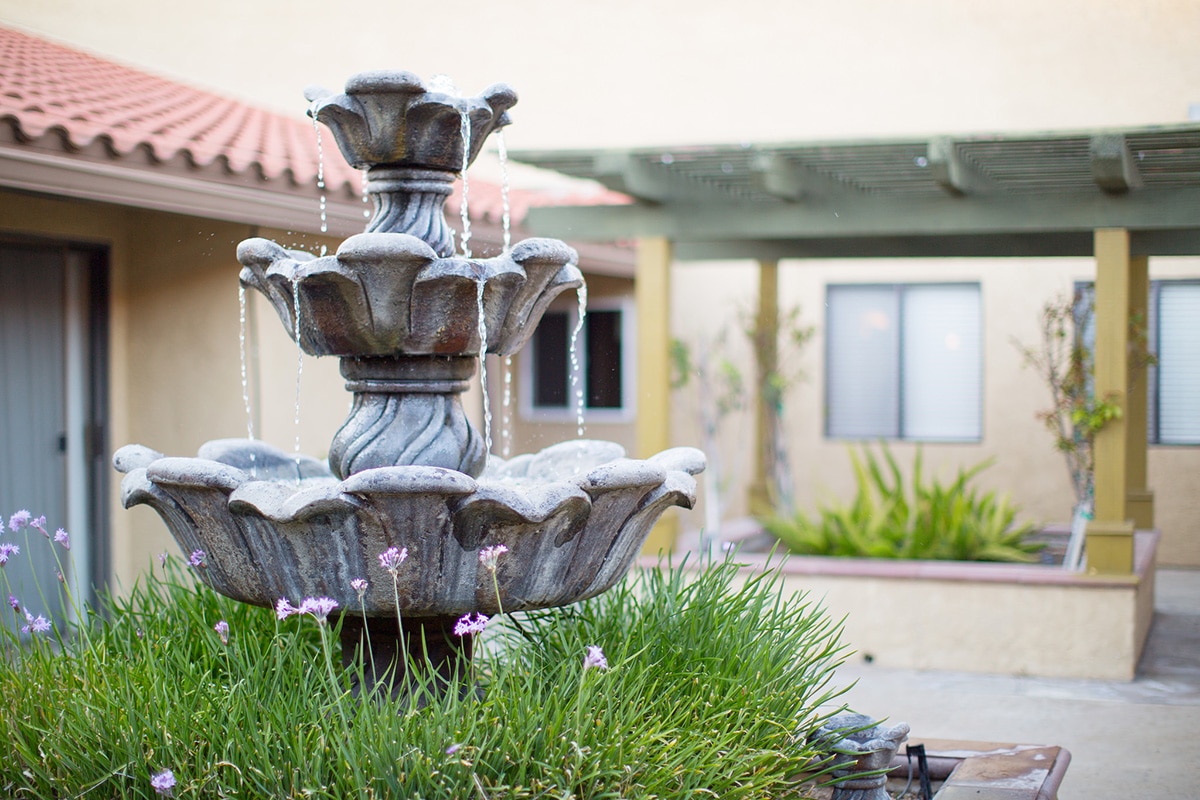 Water fountain and greenery in the Poway Healthcare courtyard