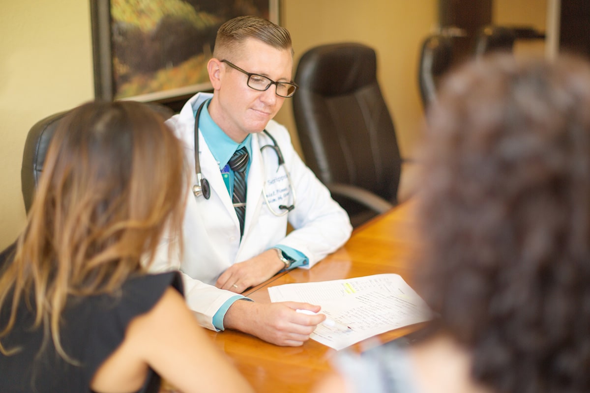 caregivers sitting at a conference room table at Poway Healthcare