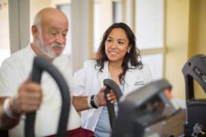 rehab therapist and resident in the rehab gym at Poway Healthcare
