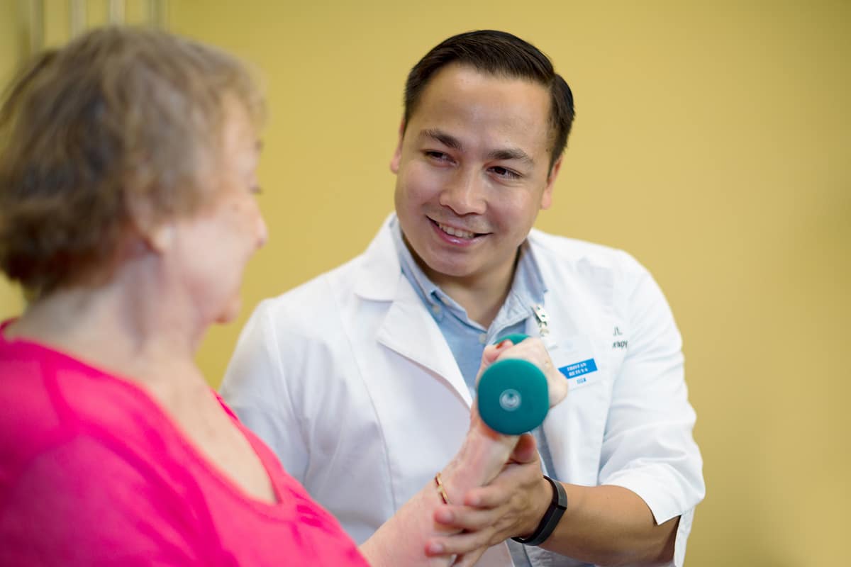 rehab therapist with a resident in the rehab gym at Poway Healthcare
