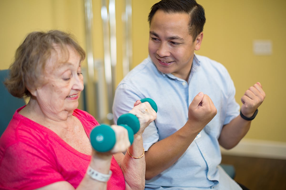 rehab therapist with a resident in the rehab gym at Poway Healthcare facility